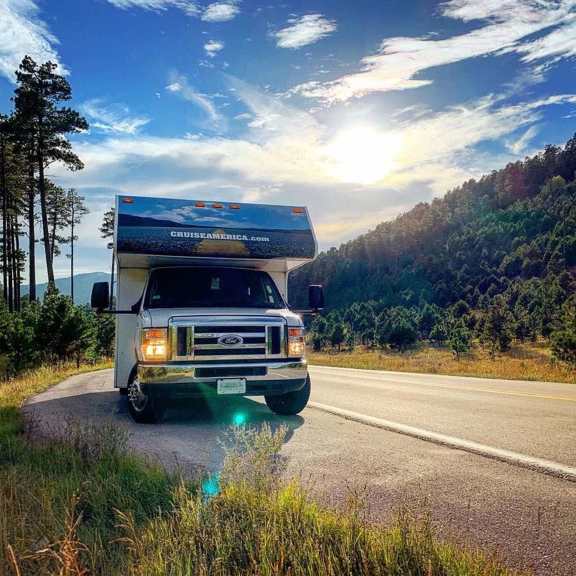Front view of RV parked on mountain road